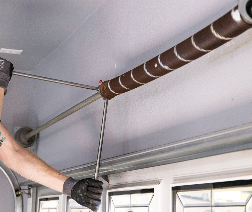 Technician performing garage door spring repair in Nokomis, FL - Dublin Garage Door Repair services