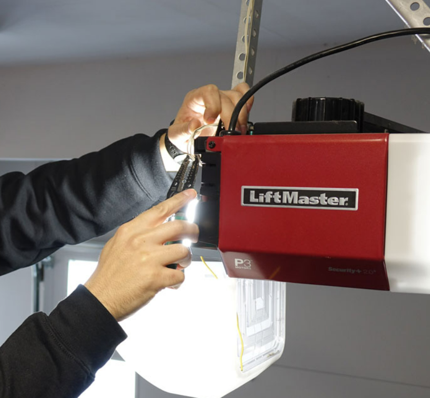 Professional technician performing garage door opener repair in Nokomis, FL.