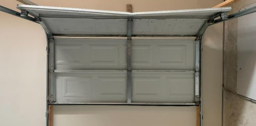 Professional performing garage door panel repair with tools and equipment in Nokomis, FL - Dublin Garage Door Repair service.