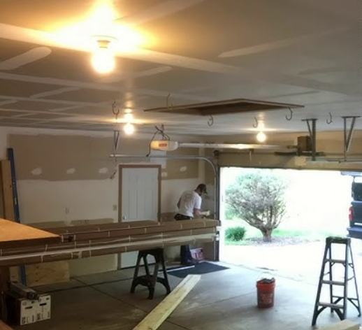 Technician performing garage door section replacement in Nokomis, FL, showcasing professional repair services by Dublin Garage Door Repair.