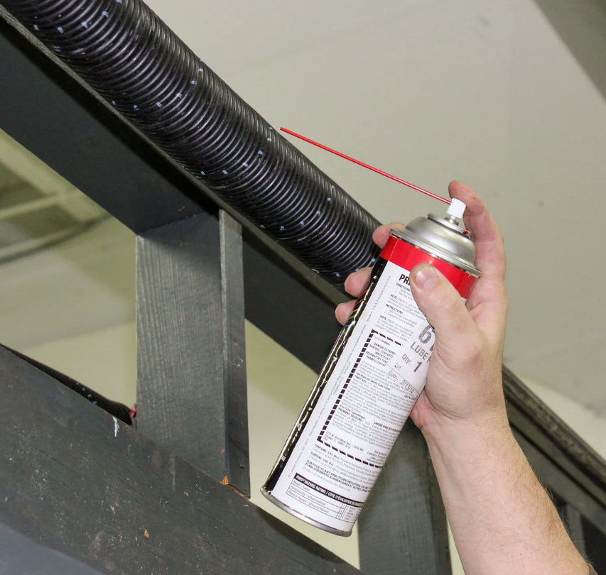 Technician fixing a noisy garage door with professional tools during a repair in Nokomis, FL